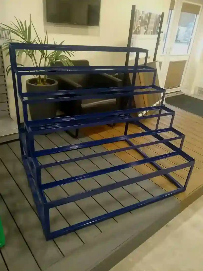 Custom storage shelving powder coated in dark blue, industrial finishing by Powderplus Haverhill